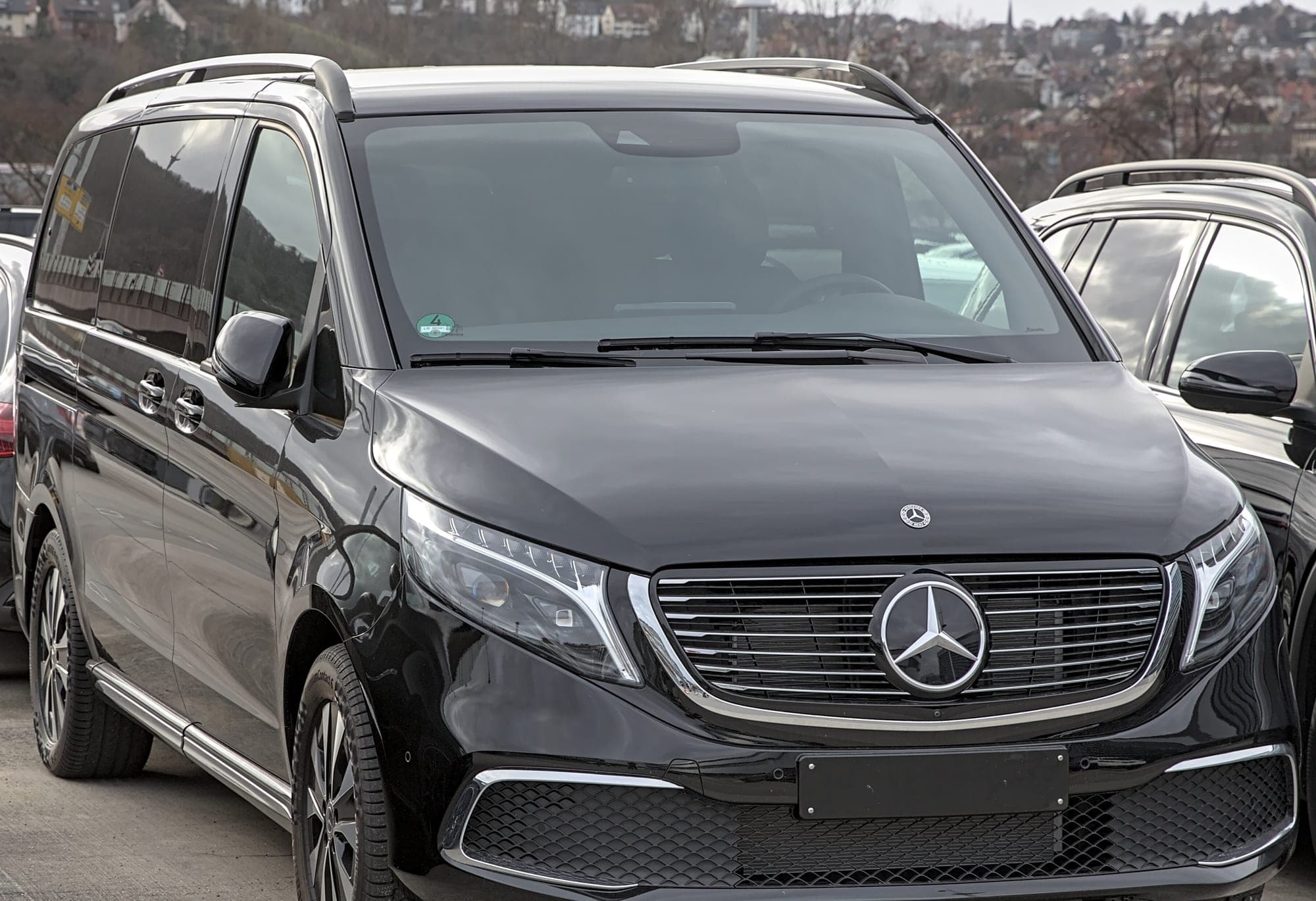 A black Mercedes-Benz V-Class people carrier, the type of vehicle used for group and airport journeys.